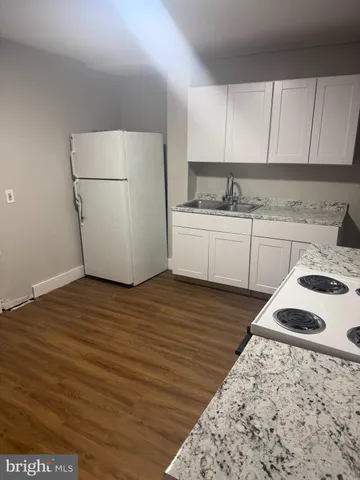a kitchen with a sink a stove and refrigerator