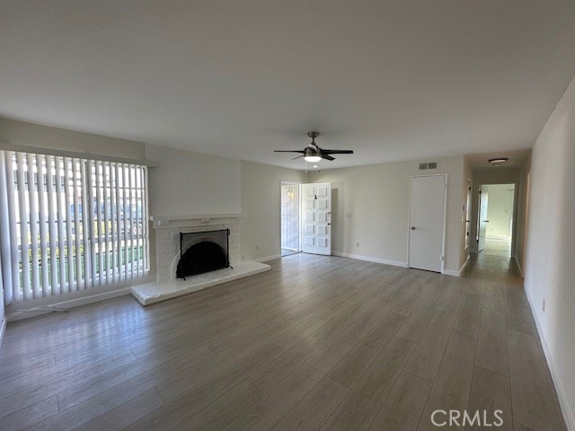 17061 Grove Circle, Unit A Huntington Beach, CA 92647 - Photo 12 of 30 an empty room with wooden floor fan and windows