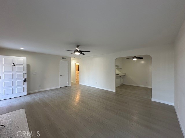 17061 Grove Circle, Unit A Huntington Beach, CA 92647 - Photo 13 of 30 an empty room with wooden floor and windows