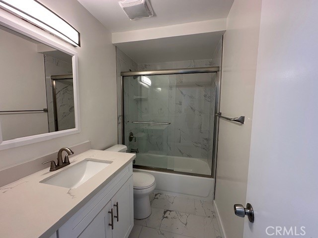 17061 Grove Circle, Unit A Huntington Beach, CA 92647 - Photo 18 of 30 a bathroom with a granite countertop sink toilet and shower