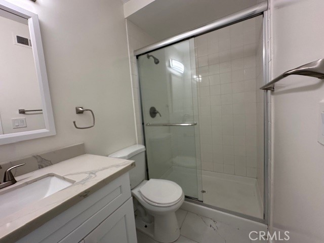 17061 Grove Circle, Unit A Huntington Beach, CA 92647 - Photo 20 of 30 a bathroom with a granite countertop sink toilet and shower