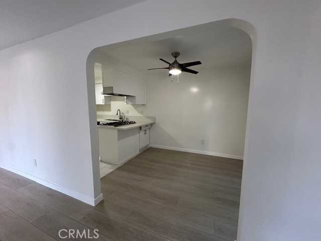 17061 Grove Circle, Unit A Huntington Beach, CA 92647 - Photo 3 of 30 a kitchen with granite countertop a sink and a stove top oven
