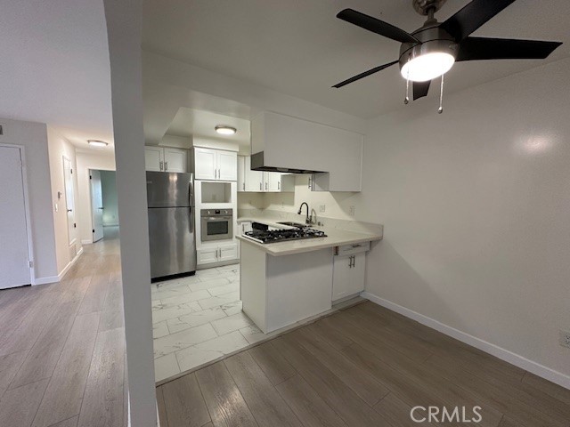 17061 Grove Circle, Unit A Huntington Beach, CA 92647 - Photo 4 of 30 a kitchen with a refrigerator and a stove top oven