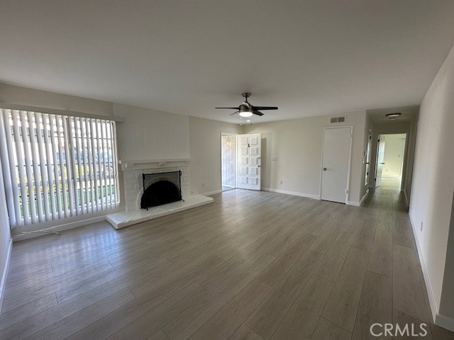 17061 Grove Circle, Unit A Huntington Beach, CA 92647 - Photo 10 of 30 a view of an empty room with wooden floor and a window