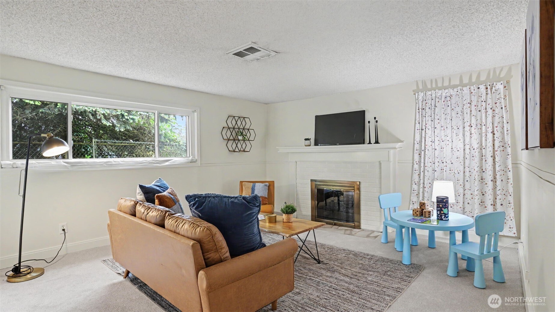 12515 Southeast 171st Street Renton, WA 98058 - Photo 15 of 24 a living room with furniture a flat screen tv and a fireplace