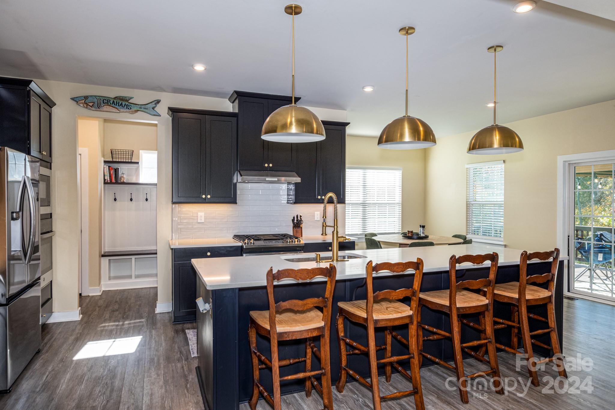 14306 Sunnyhill Grove Road Davidson, NC 28036 - Photo 14 of 35 a dining table with chairs and wooden floor