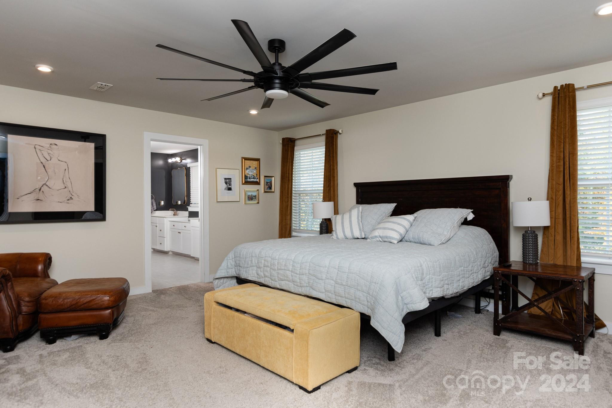 14306 Sunnyhill Grove Road Davidson, NC 28036 - Photo 15 of 35 a bedroom with a bed a couch and a chandelier