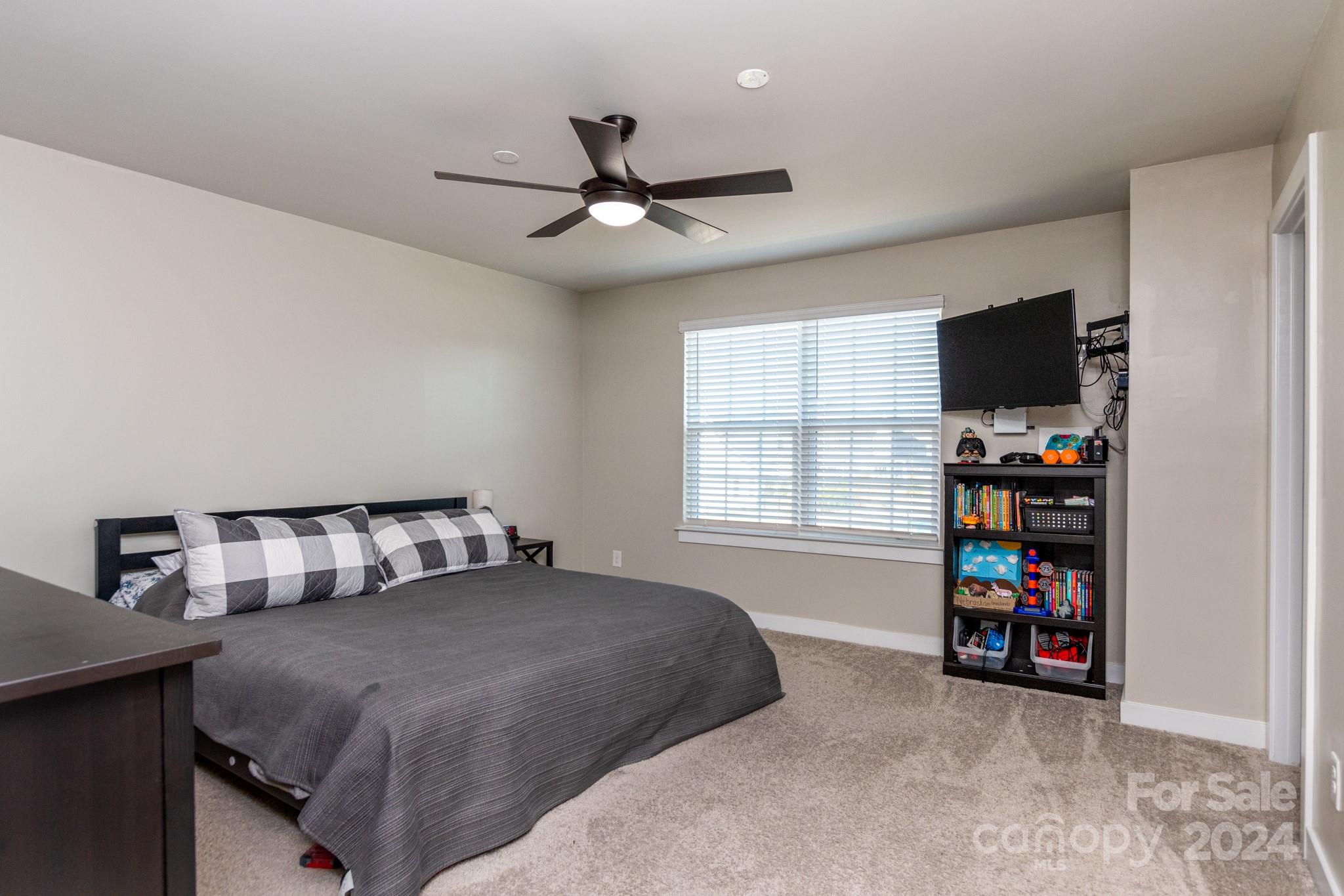 14306 Sunnyhill Grove Road Davidson, NC 28036 - Photo 17 of 35 a bedroom with a bed and a tv