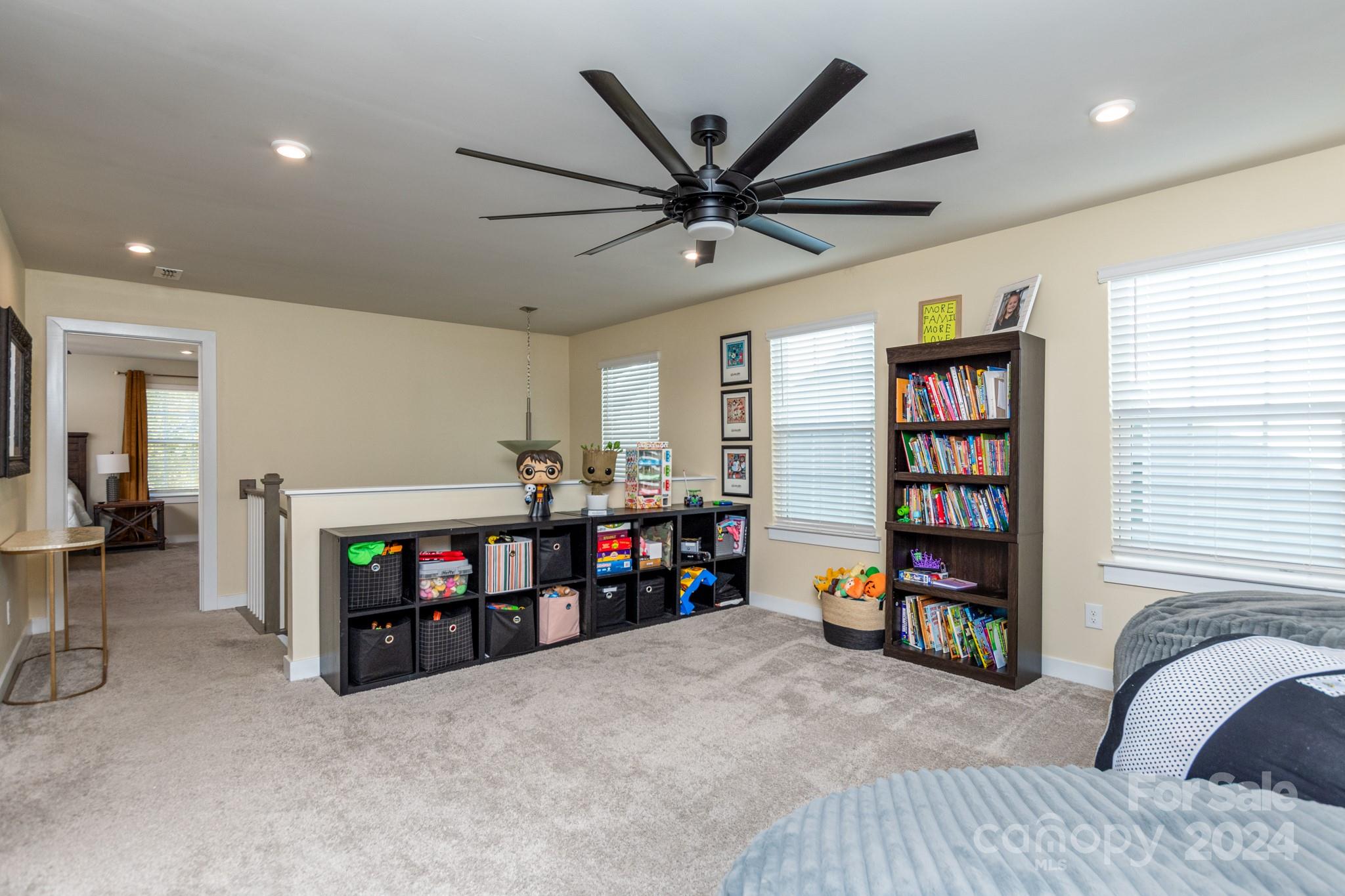 14306 Sunnyhill Grove Road Davidson, NC 28036 - Photo 23 of 35 a living room with furniture and a flat screen tv