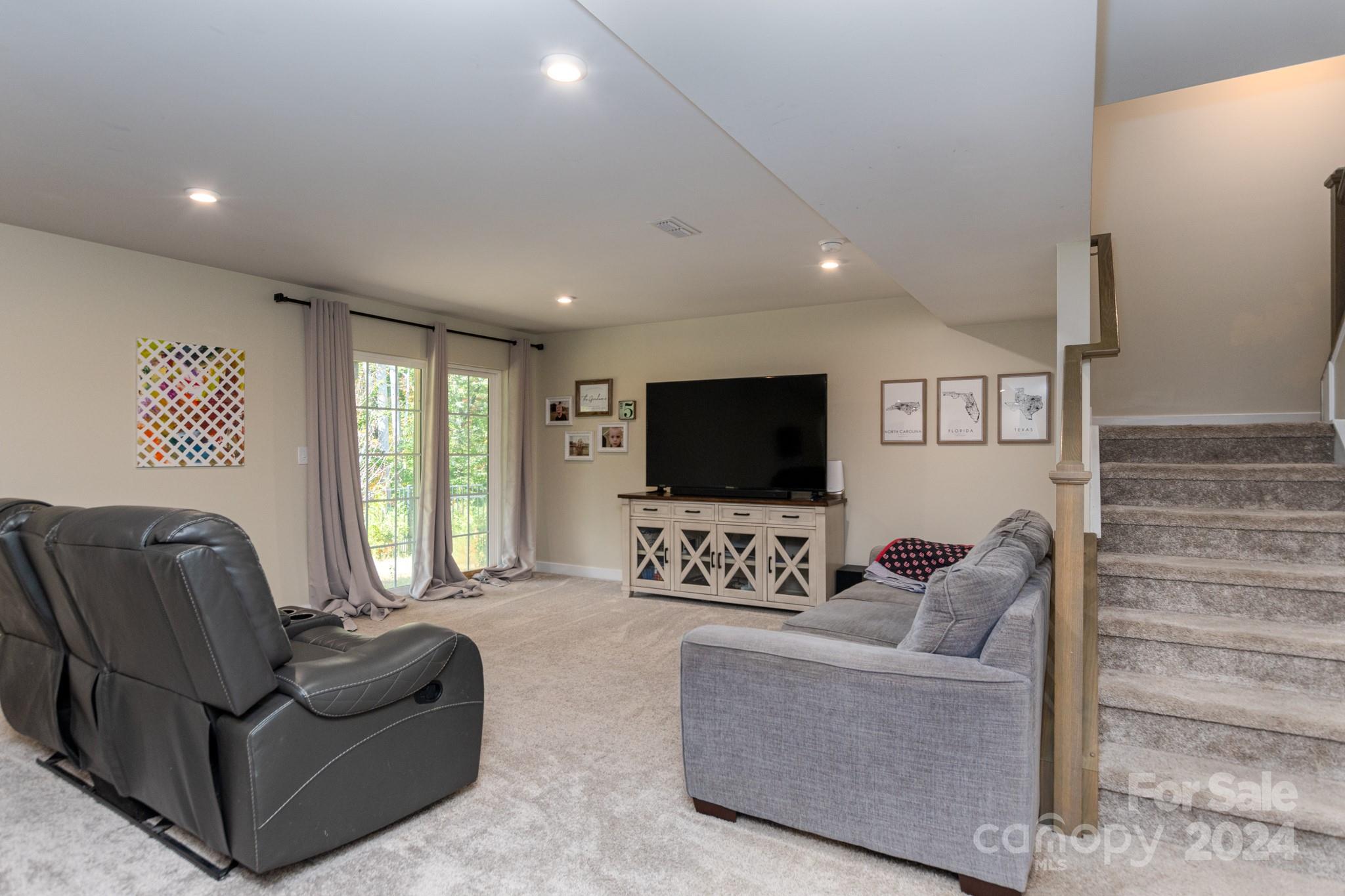 14306 Sunnyhill Grove Road Davidson, NC 28036 - Photo 25 of 35 a living room with furniture and a flat screen tv