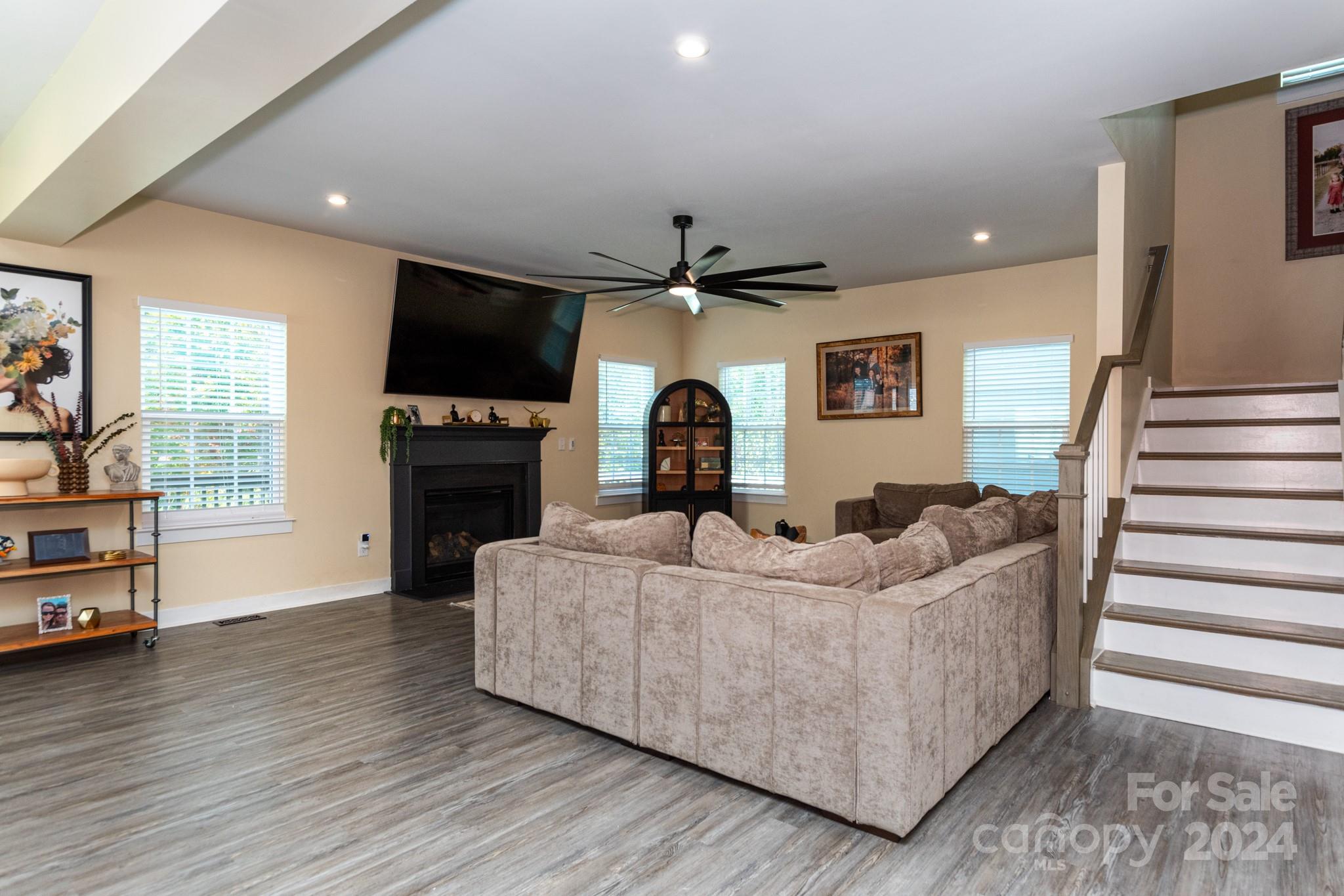 14306 Sunnyhill Grove Road Davidson, NC 28036 - Photo 10 of 35 a living room with furniture and a flat screen tv