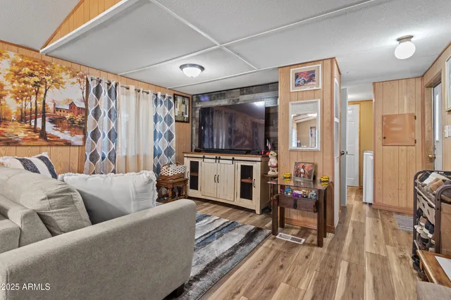a view of living room kitchen and entryway