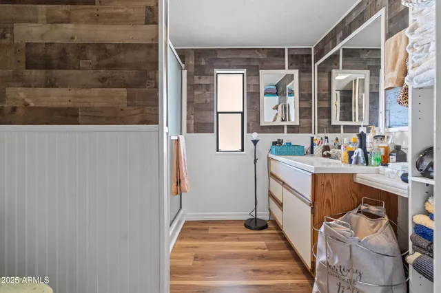 a close view of walk in closet with clothes and shoes