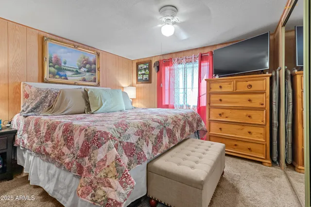 a bedroom with a bed and a mirror