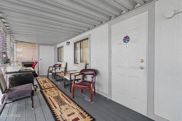 a palm tree sitting in front of a building with cars
