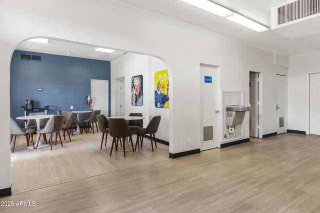 a view of a dining room with furniture and a book shelf