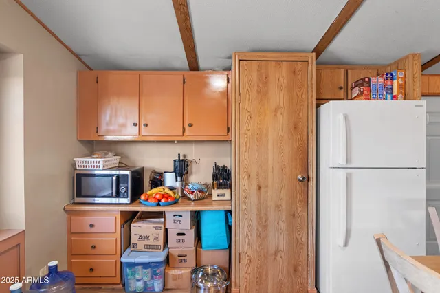 a kitchen with a refrigerator and cabinets