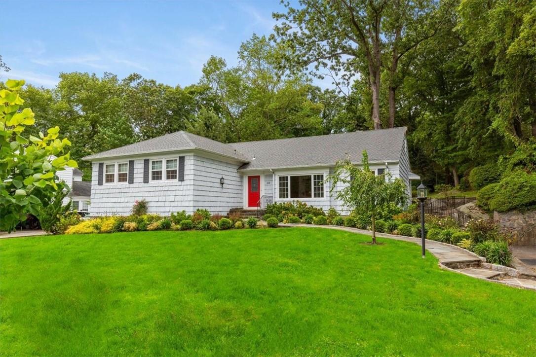 22 Ramapo Trail Harrison, NY 10528 - Photo 1 of 1 a front view of a house with a garden