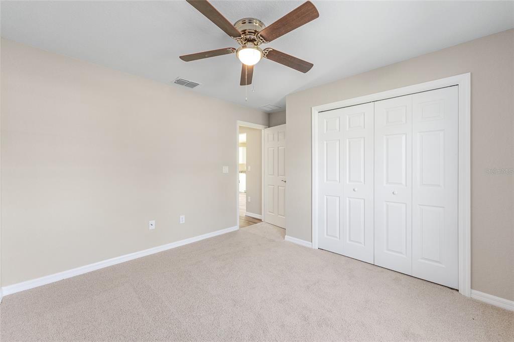 17574 Southwest 112th Place Dunnellon, FL 34432 - Photo 16 of 26 an empty room with chandelier fan