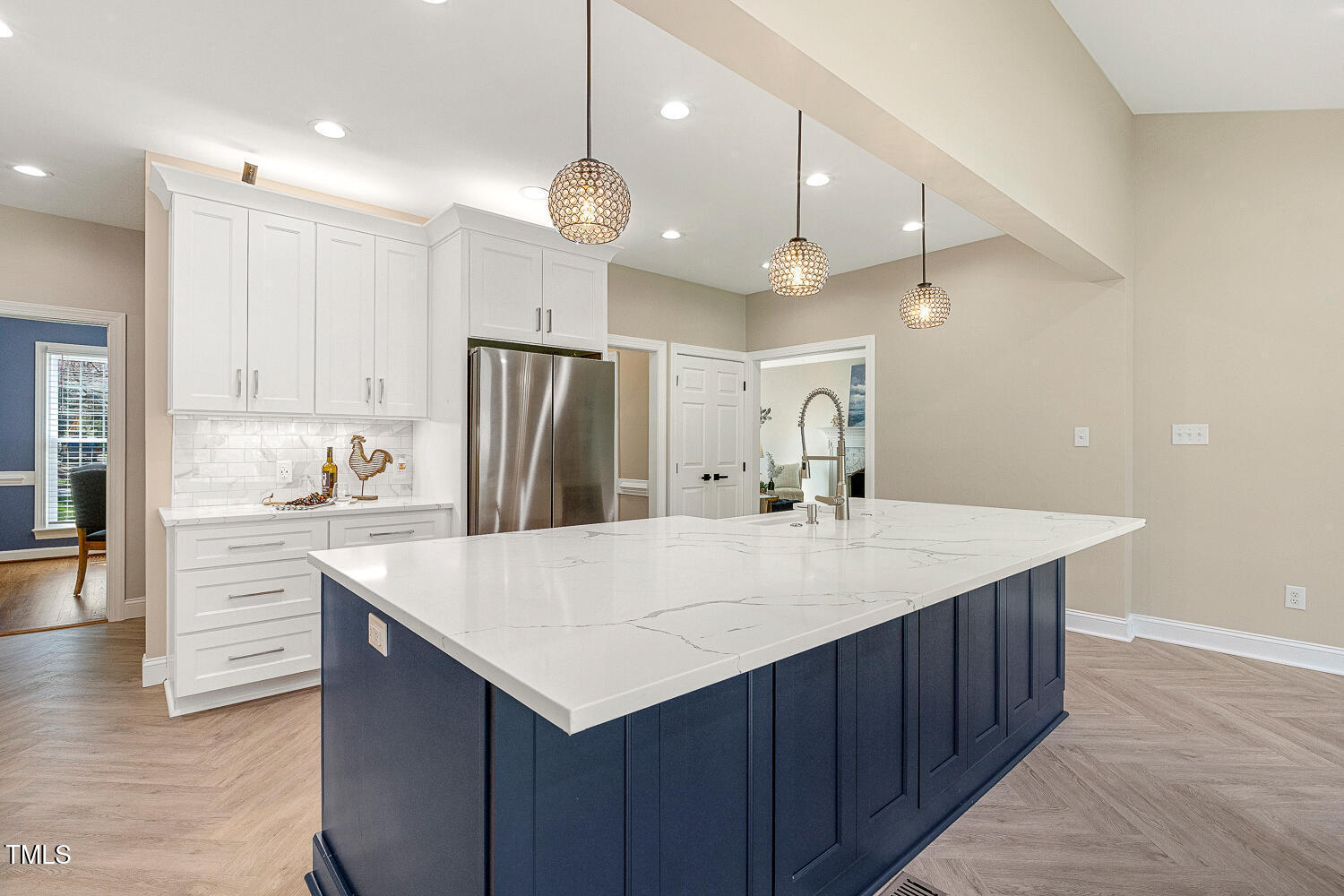 6320 Bayswater Trail Raleigh, NC 27612 - Photo 11 of 62 a large kitchen with a large center island white cabinets and stainless steel appliances