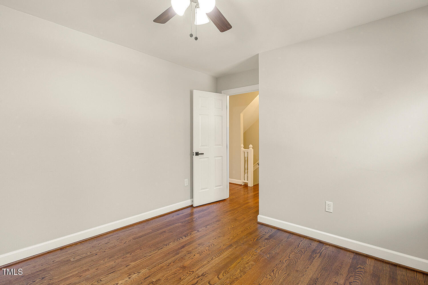 6320 Bayswater Trail Raleigh, NC 27612 - Photo 40 of 62 an empty room with wooden floor and a ceiling fan