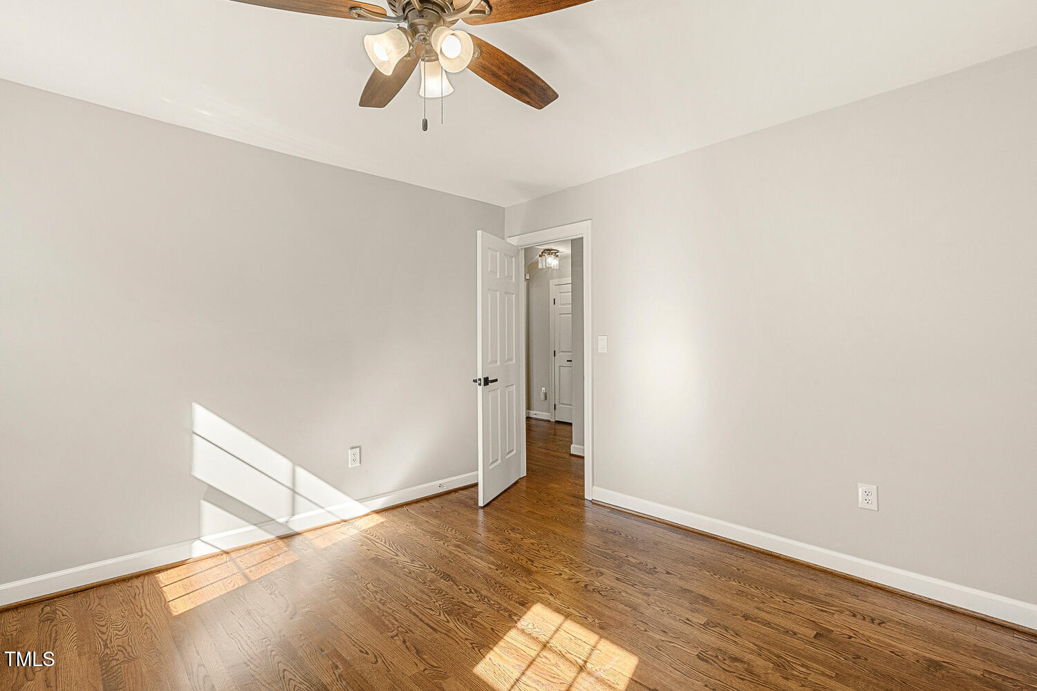 6320 Bayswater Trail Raleigh, NC 27612 - Photo 44 of 62 an empty room with wooden floor fan and windows