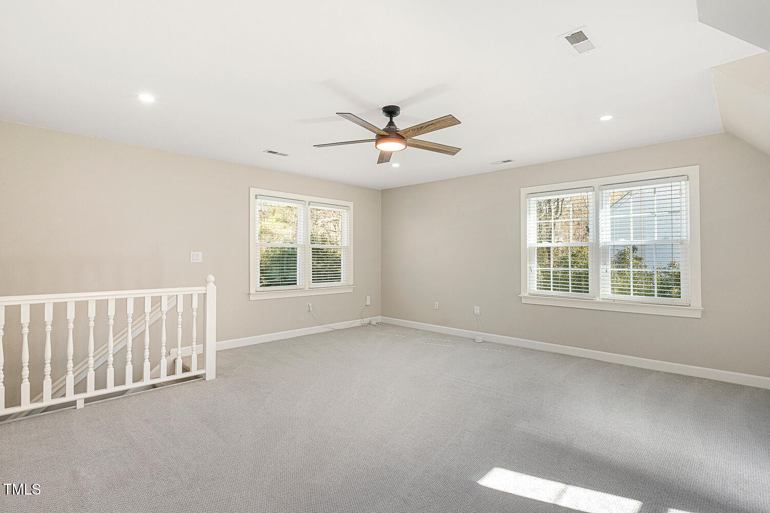 6320 Bayswater Trail Raleigh, NC 27612 - Photo 46 of 62 an empty room with chandelier fan and windows