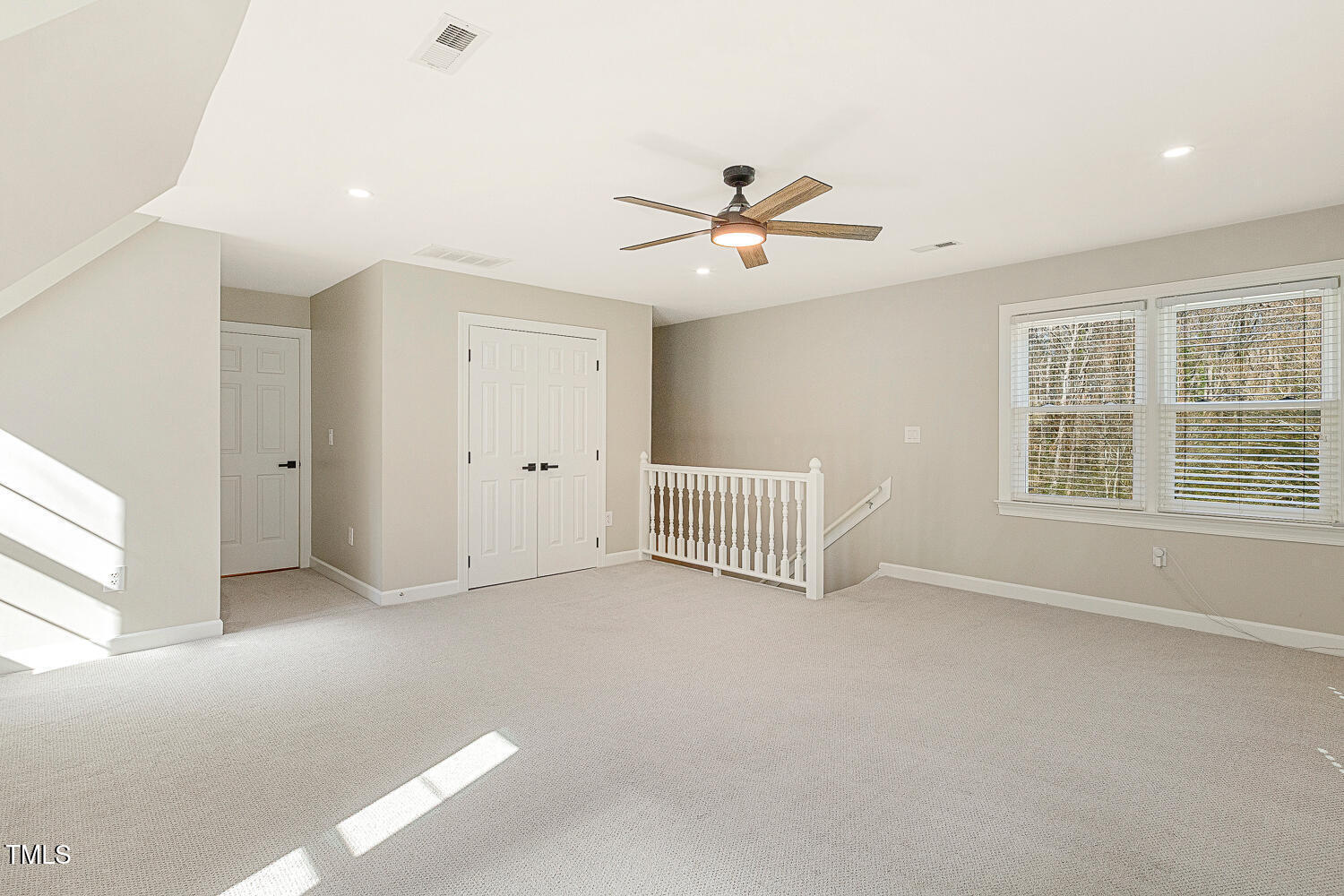 6320 Bayswater Trail Raleigh, NC 27612 - Photo 49 of 62 en empty room with windows and ceiling fan