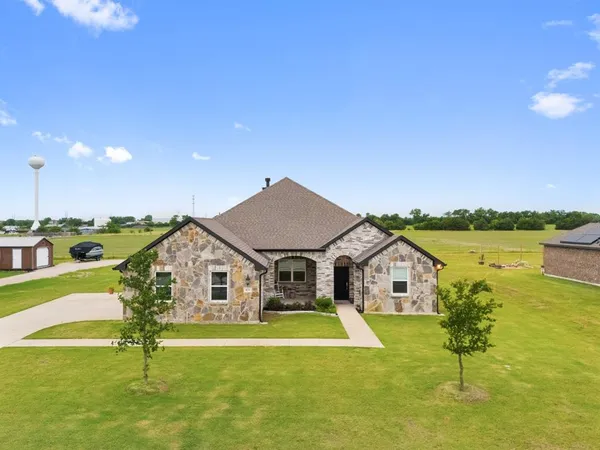 an aerial view of a house with outdoor space and lake view