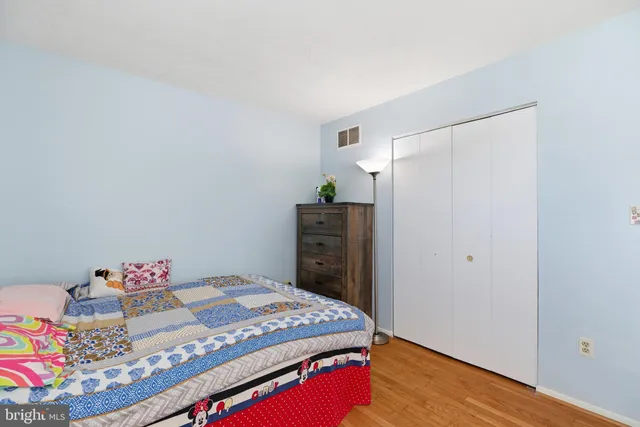 a bedroom with a bed and a dresser