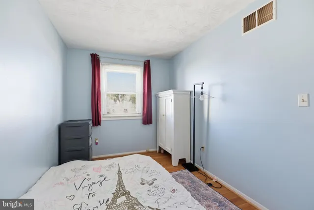 a bedroom with a bed and a dresser