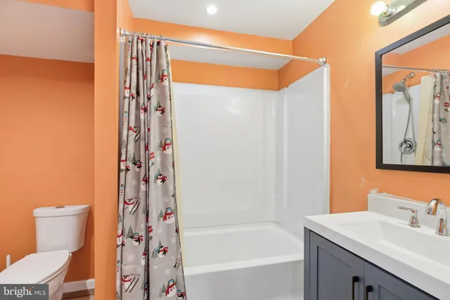 a bathroom with a shower curtain and a sink