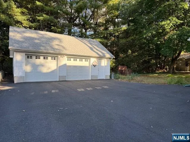 a view of a house with a yard and garage