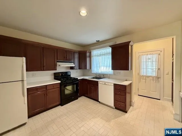 a kitchen with a stove top oven sink and cabinets