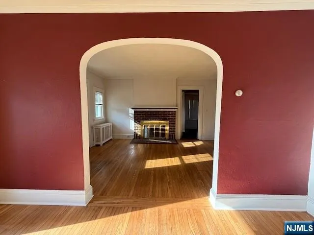 a view of a living room with wooden floor