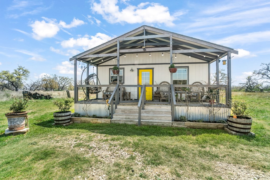 3527 Old Harper Road Fredericksburg, TX 78624 - Photo 3 of 41 a front view of a house with garden