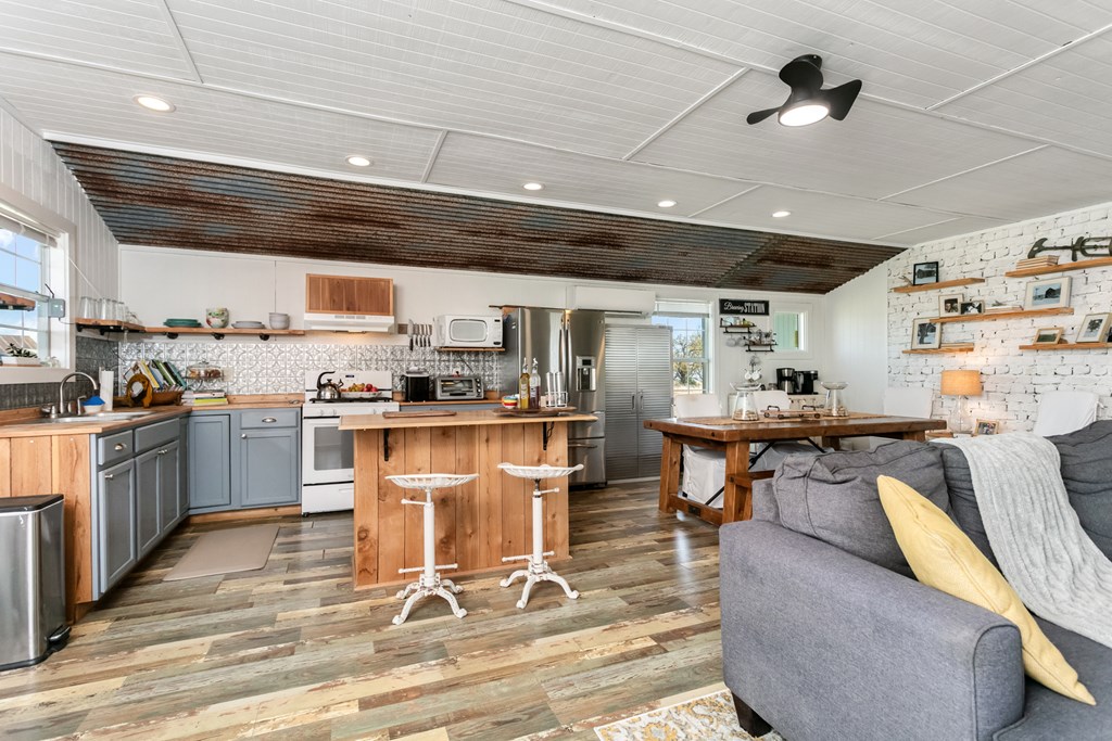 3527 Old Harper Road Fredericksburg, TX 78624 - Photo 4 of 41 a kitchen with stainless steel appliances kitchen island granite countertop lots of counter top space