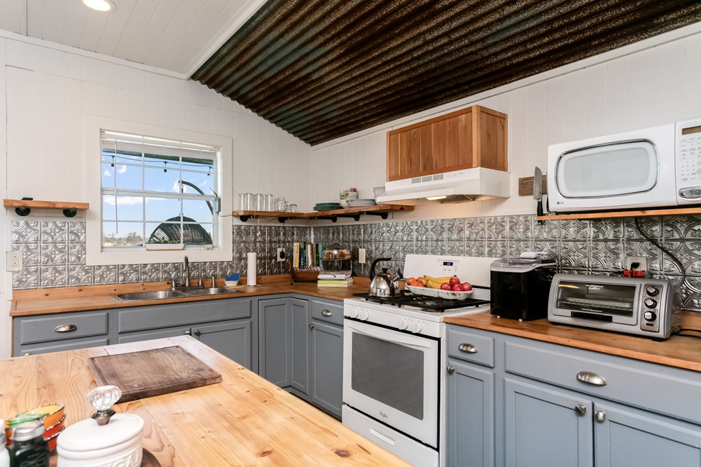 3527 Old Harper Road Fredericksburg, TX 78624 - Photo 5 of 41 a kitchen with a sink stove and cabinets