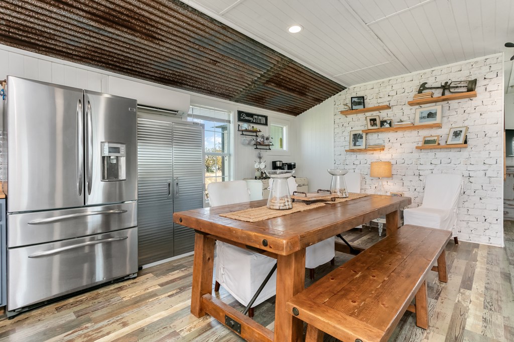3527 Old Harper Road Fredericksburg, TX 78624 - Photo 6 of 41 a kitchen with stainless steel appliances granite countertop a refrigerator a sink dishwasher a stove and a refrigerator with wooden floor