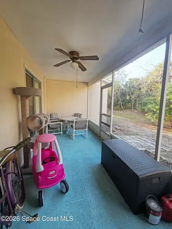 a bedroom with furniture and a large window