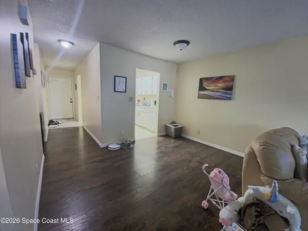 a view of a room with wooden floor and lounge chair
