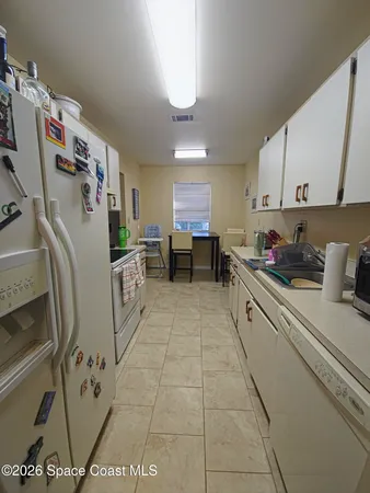 a kitchen with stainless steel appliances granite countertop a sink a stove a refrigerator and cabinets