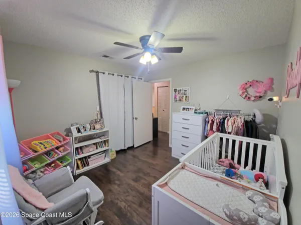 a bedroom with furniture and baby crib