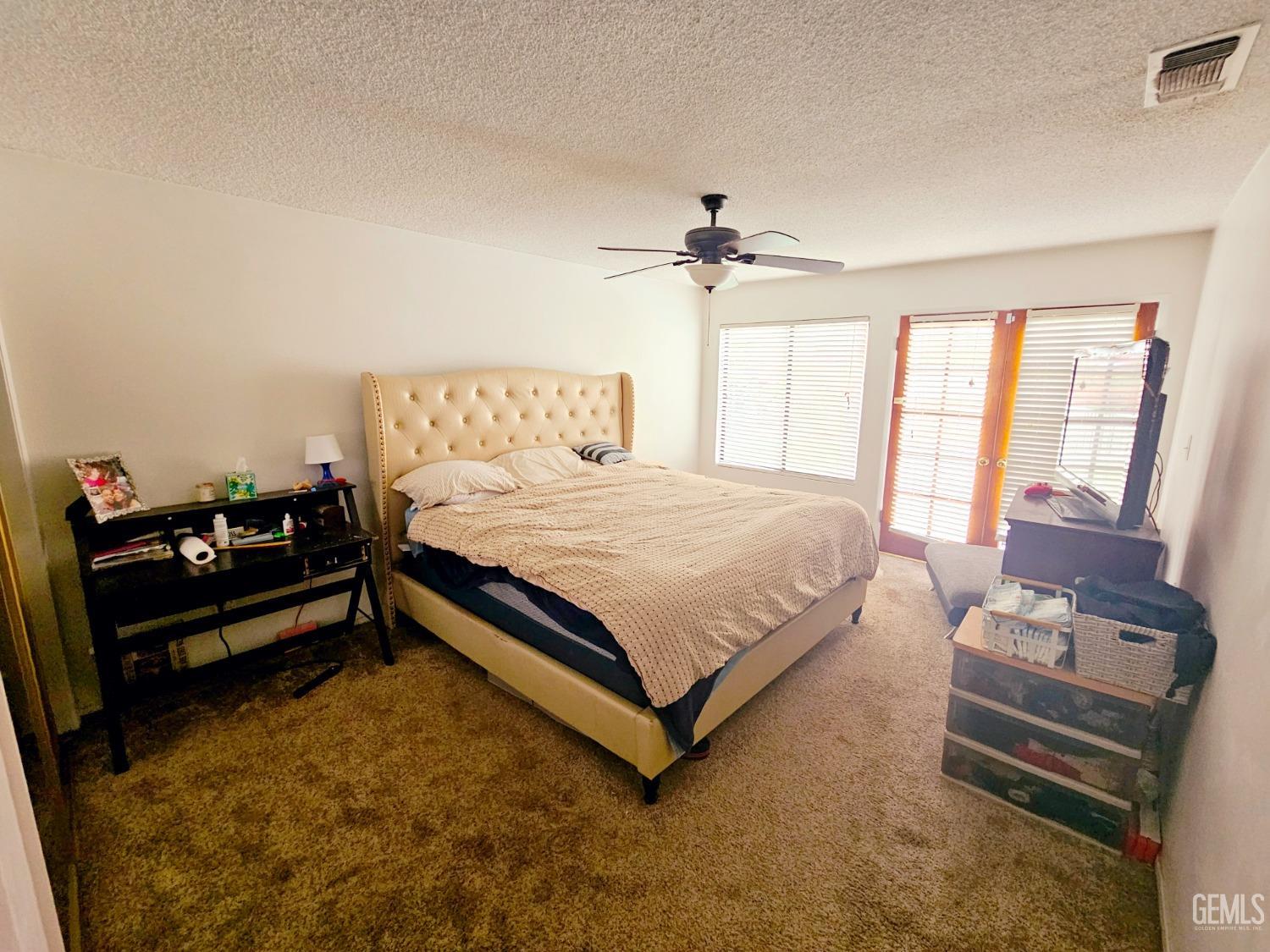 Undisclosed Address Bakersfield, CA 93309 - Photo 19 of 28 a bedroom with a bed mirror and a window