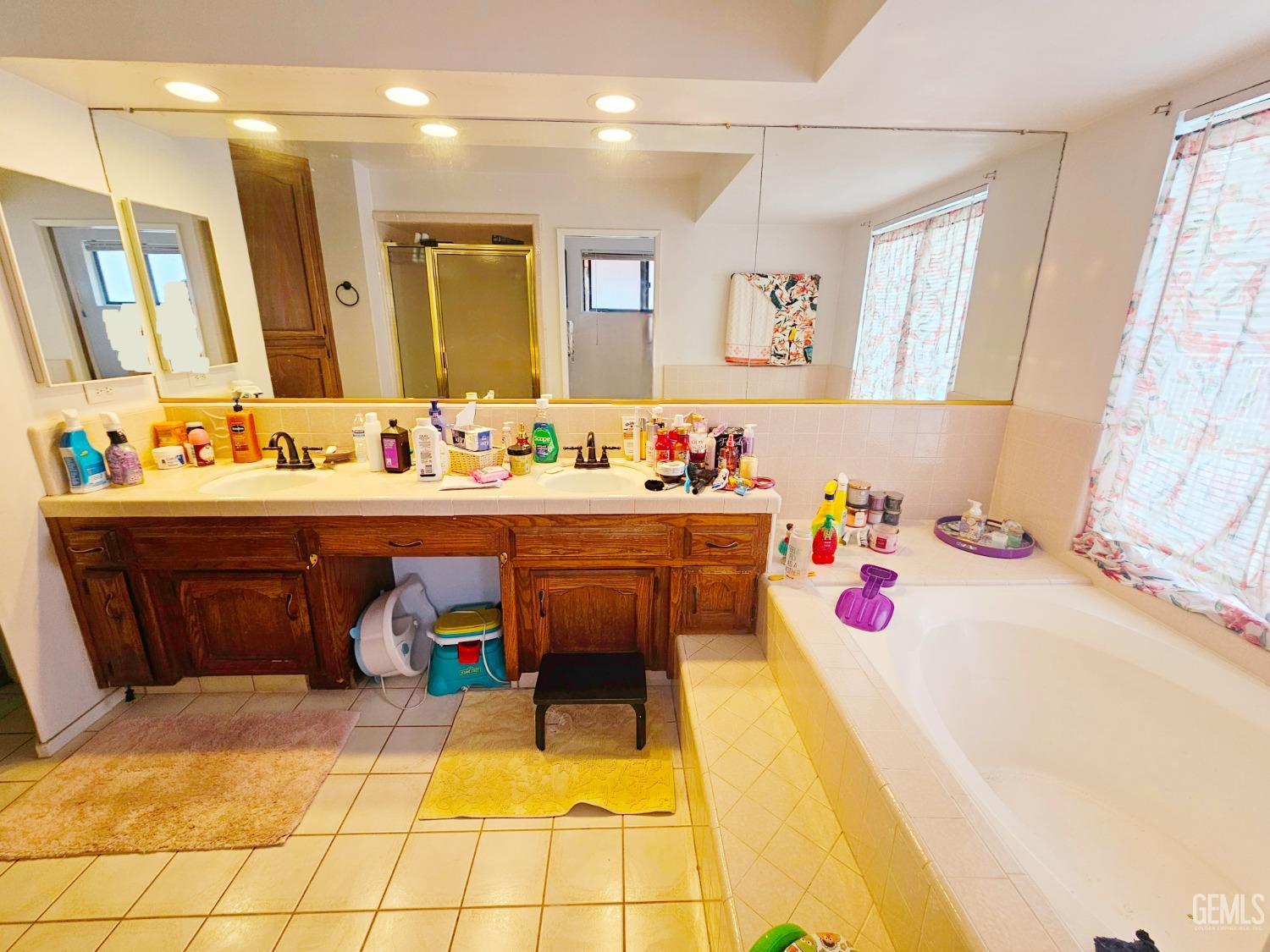 Undisclosed Address Bakersfield, CA 93309 - Photo 20 of 28 a bathroom with a tub sink and mirror