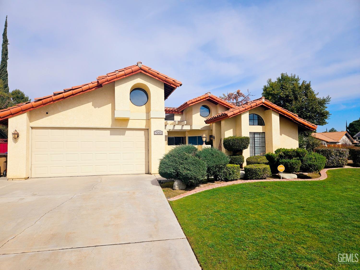 Undisclosed Address Bakersfield, CA 93309 - Photo 27 of 28 a front view of a house with a yard and garage