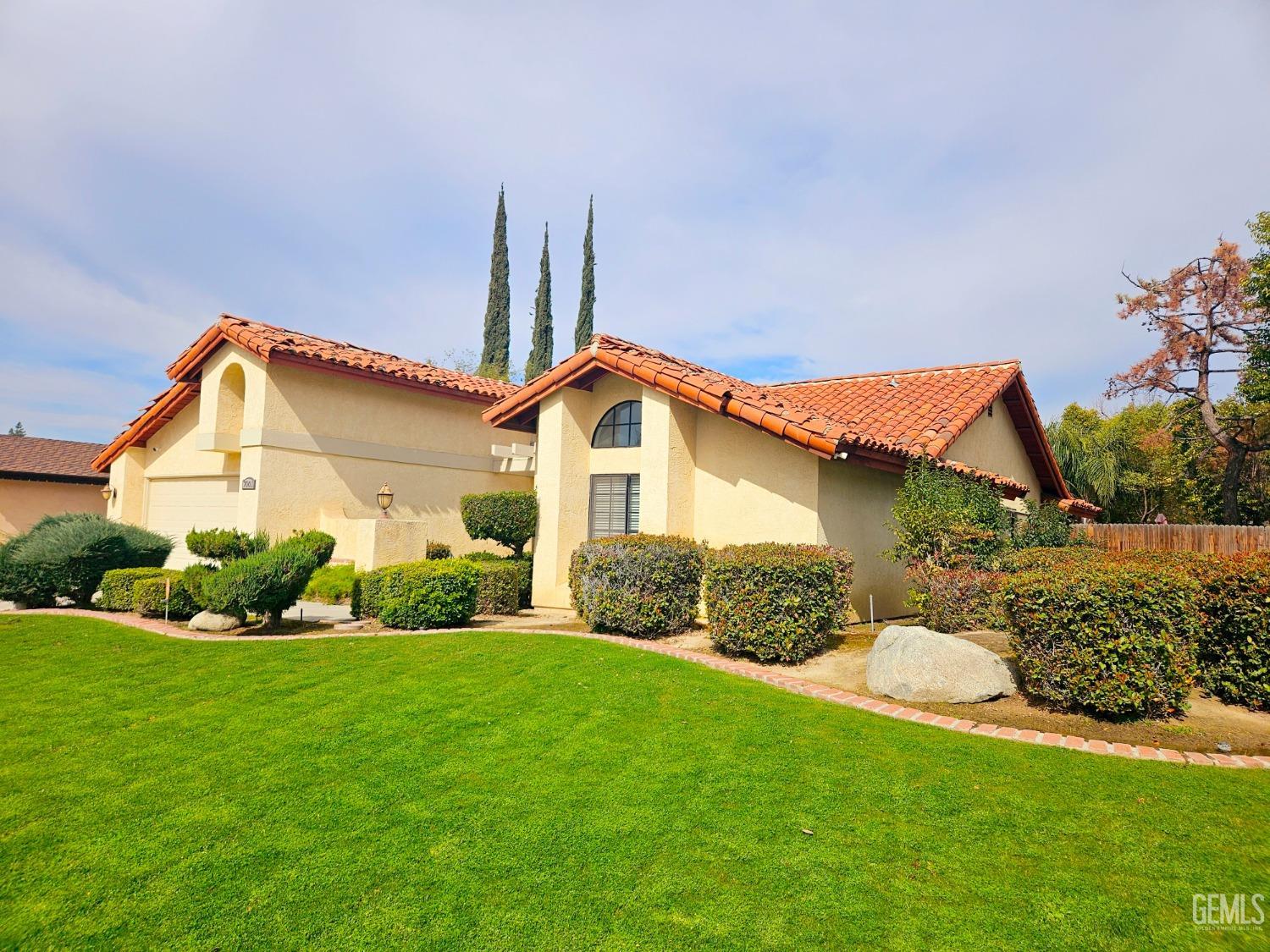 Undisclosed Address Bakersfield, CA 93309 - Photo 3 of 28 a front view of a house with a yard