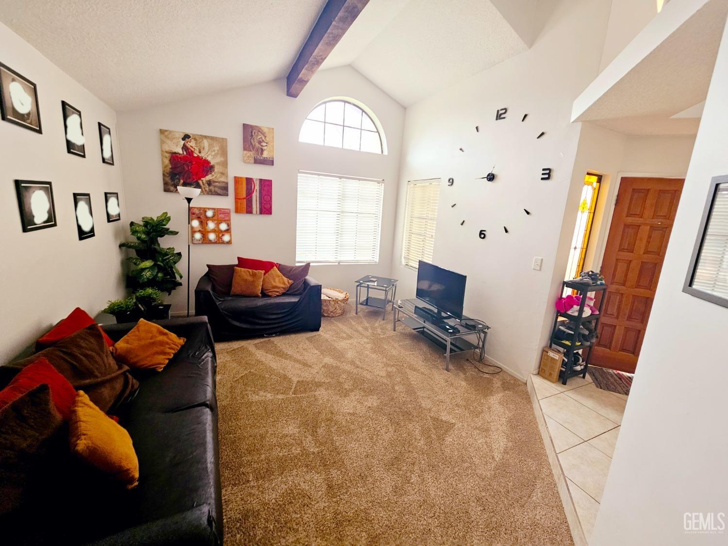 Undisclosed Address Bakersfield, CA 93309 - Photo 6 of 28 a living room with furniture a flat screen tv and a fireplace