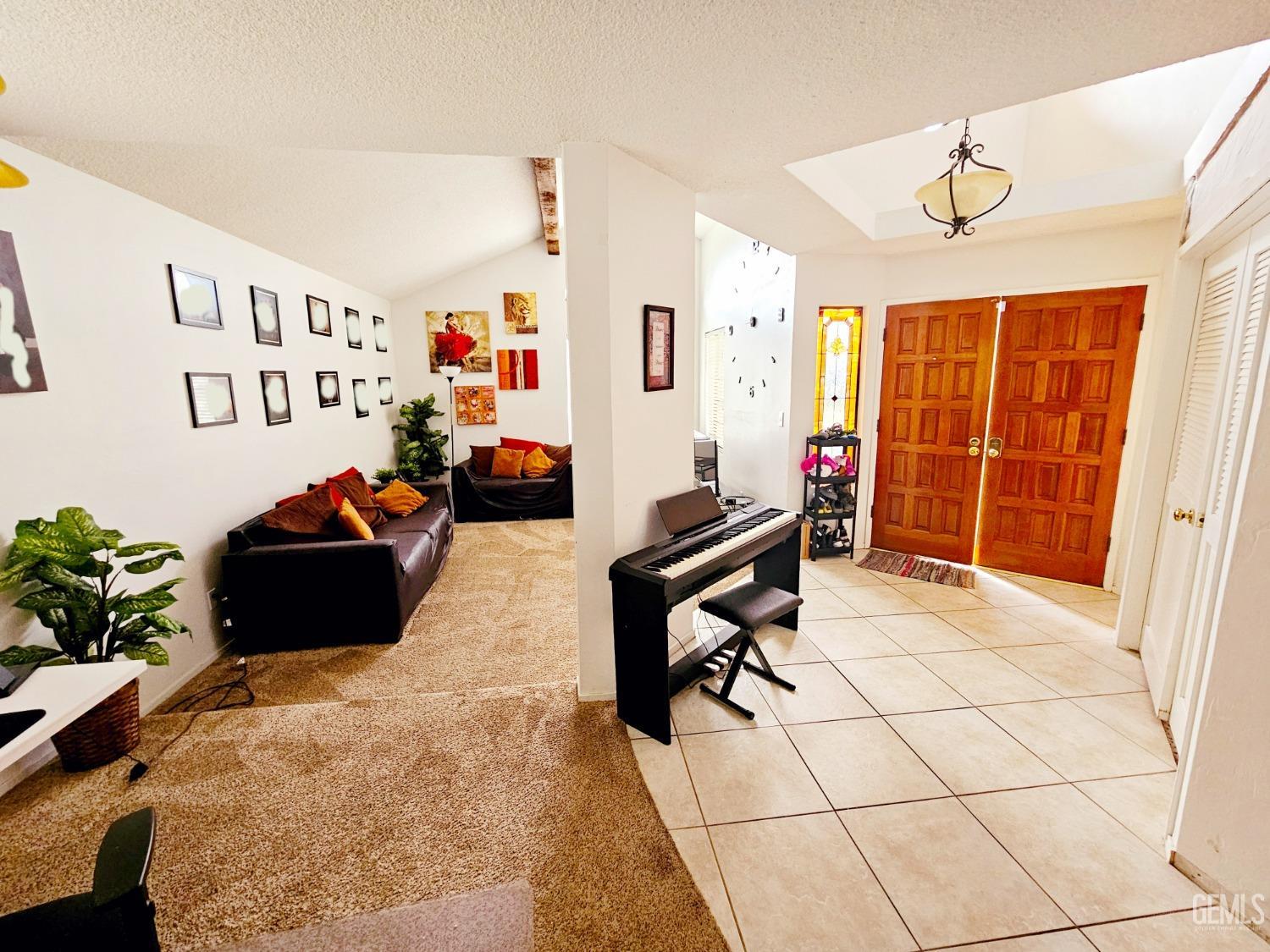Undisclosed Address Bakersfield, CA 93309 - Photo 7 of 28 a living room with furniture gym equipment and a chandelier