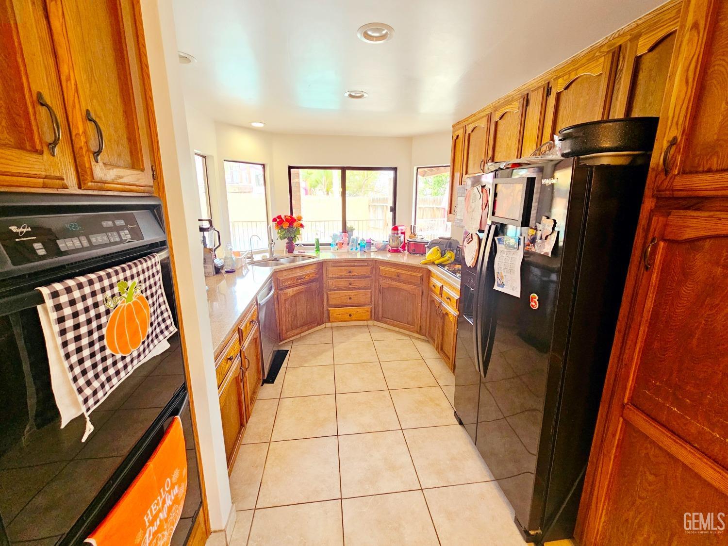 Undisclosed Address Bakersfield, CA 93309 - Photo 8 of 28 a view of a kitchen with furniture and a refrigerator